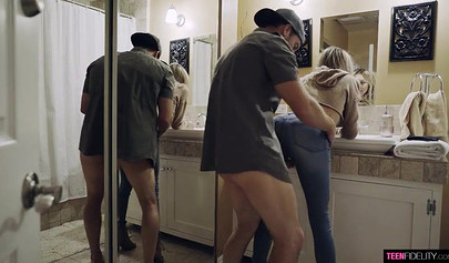 A tiny blonde teen with tight jeans and glasses drops to her knees