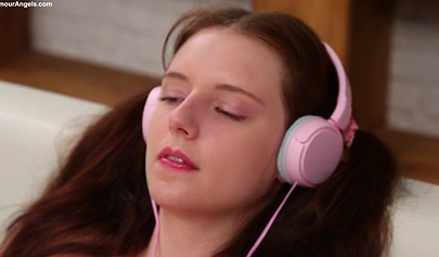 Cute brunette teen in a pink t-shirt and jean shorts puts on a good show