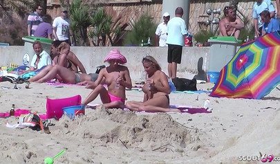 Lesbian teen couple has sex on the beach while the public is watching carefully