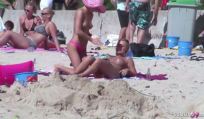 Lesbian teen couple has sex on the beach while the public is watching carefully