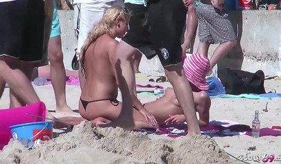 Lesbian teen couple has sex on the beach while the public is watching carefully