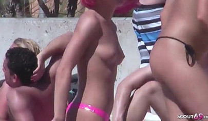 Lesbian teen couple has sex on the beach while the public is watching carefully