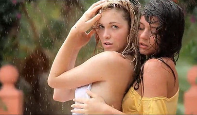 Two hot teens get really wet in the garden and they show their bodies off too