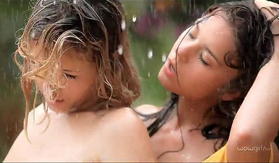 Two hot teens get really wet in the garden and they show their bodies off too