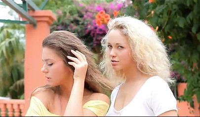 Two hot teens get really wet in the garden and they show their bodies off too