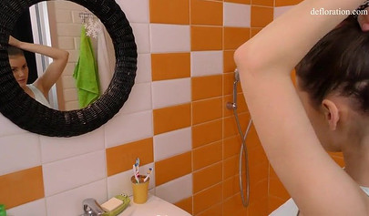 Innocent nubile with a gorgeous body masturbates in the shower until an orgasm