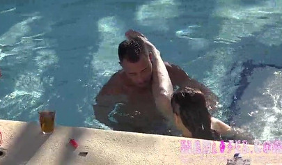 Beautiful dark-haired teen sucks two hard cocks and gets spitroasted in a pool