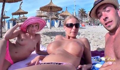 Two German teens have some fun at the beach with a guy and a black strap-on