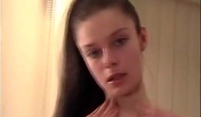 Teen brunette strips down and gets naked for an erotic performance with a dildo