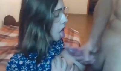 Busty teen with glasses gives a cool blowjob to her boyfriend on a web cam show