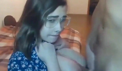 Busty teen with glasses gives a cool blowjob to her boyfriend on a web cam show