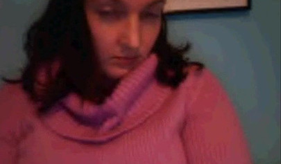 Amateur dark-haired nubile strips naked on a web cam and shows her massive boobs