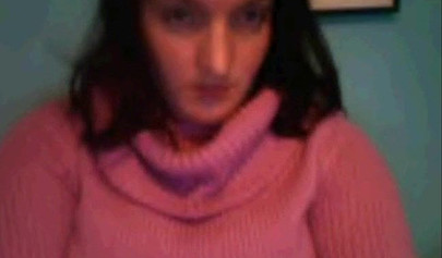 Amateur dark-haired nubile strips naked on a web cam and shows her massive boobs