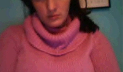 Amateur dark-haired nubile strips naked on a web cam and shows her massive boobs