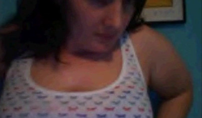 Amateur dark-haired nubile strips naked on a web cam and shows her massive boobs