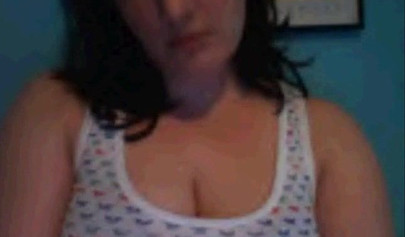 Amateur dark-haired nubile strips naked on a web cam and shows her massive boobs