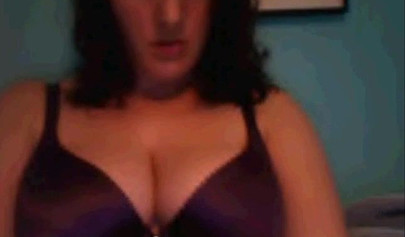 Amateur dark-haired nubile strips naked on a web cam and shows her massive boobs