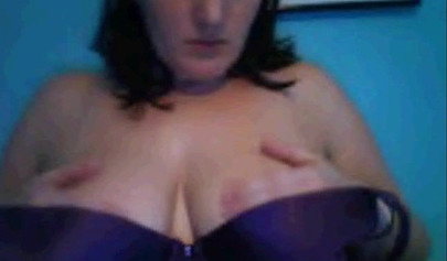 Amateur dark-haired nubile strips naked on a web cam and shows her massive boobs