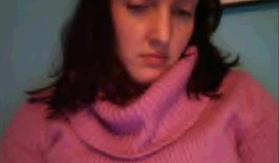 Amateur dark-haired nubile strips naked on a web cam and shows her massive boobs