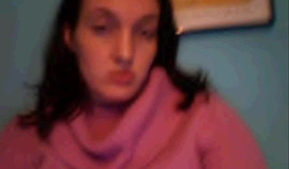 Amateur dark-haired nubile strips naked on a web cam and shows her massive boobs