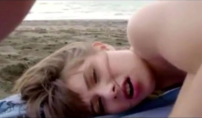 Cute teen with bangs has a threesome at the beach and gets her ass ravaged