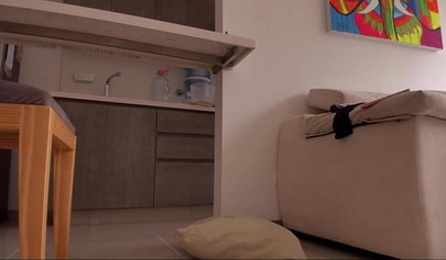 Brunette teen shows her beautiful body and smears it with lotion in the kitchen