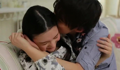 Asian teen couple making sweet and sensual love in a very comfy looking room