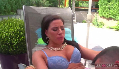 Busty brunette teen gets fucked outdoors next to a luxurious pool and eats cum