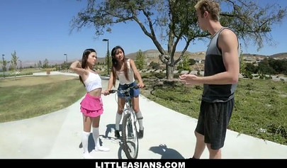 Two small Asian teen chicks share a big white dick and service it properly