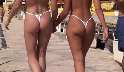 Busty babes in tiny bikinis teasing guys on the beach