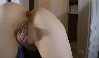 Brunette cheerleader pulls up her skirt and plays with pussy lips