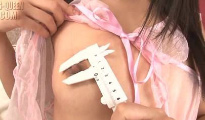 Petite Japanese girl plays with her pussy and toys it with a glass dildo