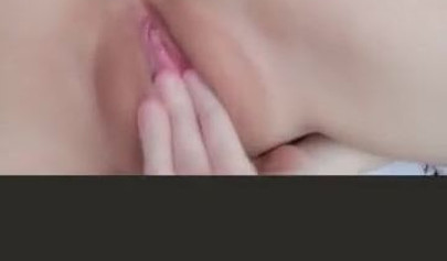 Amateur Asian girl takes off pantyhose and rubs her shaved pussy