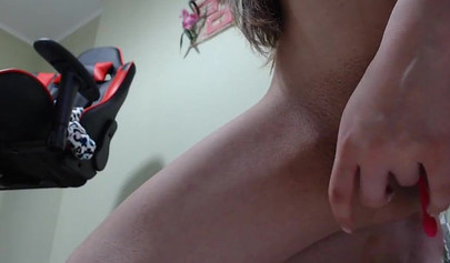 Horny nubile with a bubble butt jerks off on her gaming chair