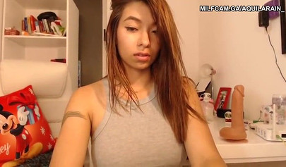 Asian teen with big boobs toys herself on a webcam