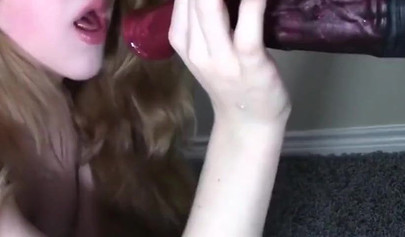 Tantalizing teen kneels and sucks a dildo like a slut