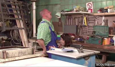 Sensual whore in fishnets fucks on a table in a workshop