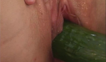 Horny girl with big boobs sticks a cucumber into her pussy