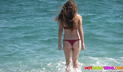 Cute babe with big boobs enjoys a day on a beach