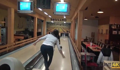 Slut with big boobs sucks her boyfriend's cock in a bowling alley