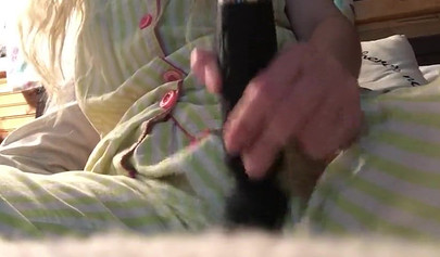 Innocent nubile uses vibrator through pajamas before stripping naked to cum hard