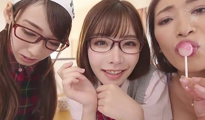 Young Japanese cuties give a sloppy blowjob before riding in a threesome