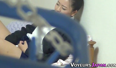 Sexy Asian teen in school uniform stroking her creamy pussy