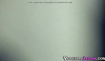 Sexy Asian teen in school uniform stroking her creamy pussy