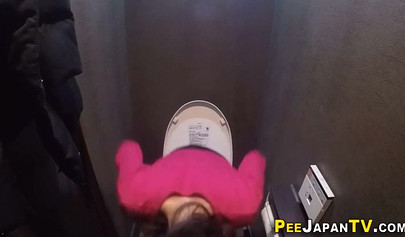 Horny Japanese teen rubbing her innocent vagina in the public toilet