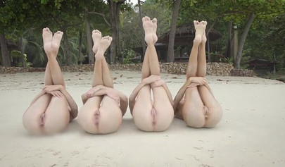 Four skinny models stripping and posing nude on the sandy beach