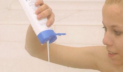 Gorgeous teen blonde washes her sexy body and poses nude