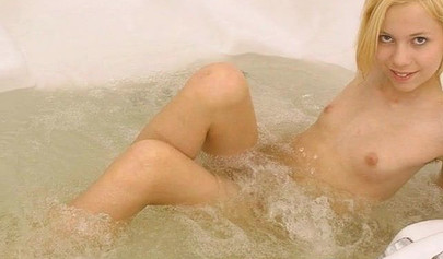 Gorgeous teen blonde washes her sexy body and poses nude