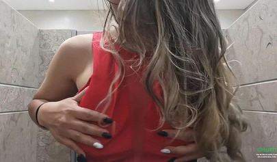 Breathtaking brunette films herself masturbating in public bathroom