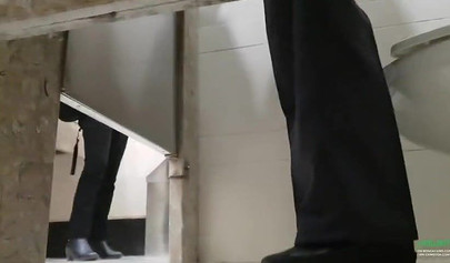 Breathtaking brunette films herself masturbating in public bathroom